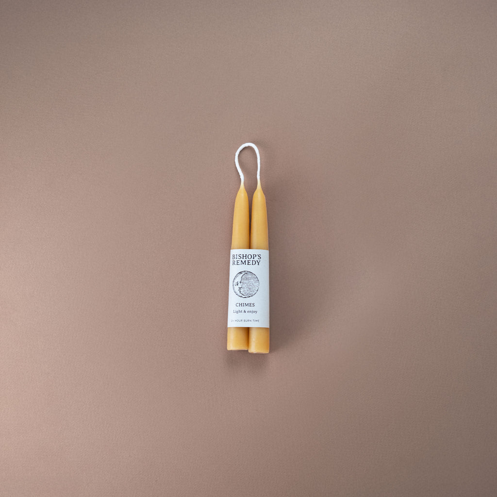 Pair of pure beeswax hand-dipped 12cm chime candles with Bishop's Remedy logo and a small moon illustration. 