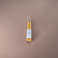 Pair of pure beeswax hand-dipped 12cm chime candles with Bishop's Remedy logo and a small moon illustration. 